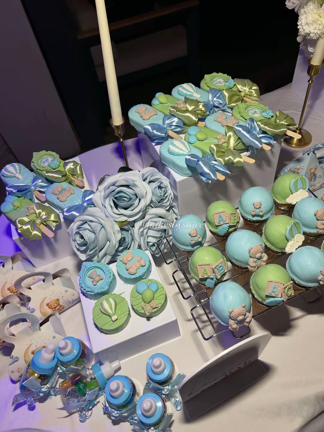 Baby shower treat table with cakesicles, chocolate covered Oreos and cake cones